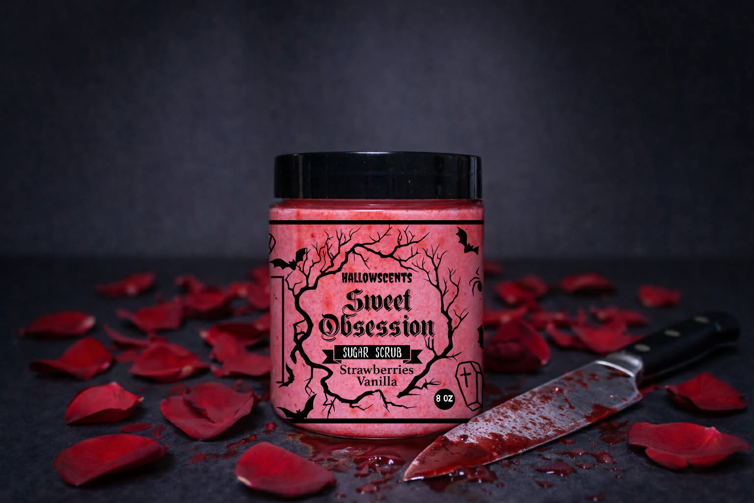 Jar of 'Sweet Obsession' whipped sugar scrub with red lighting, surrounded by red petals and a knife on a dark background. Horror themed bath and body products